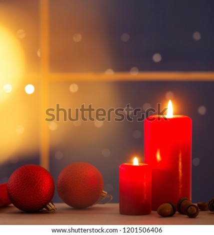 Christmas candles on background night window