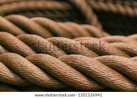 Thick brown rope rolled into a roll. Background texture