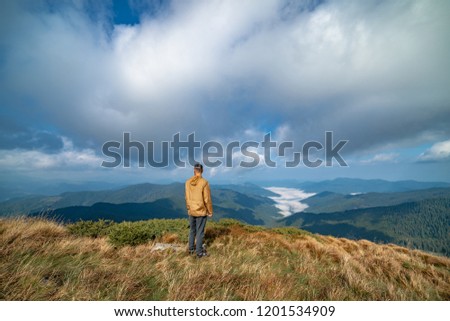 The man standing on the top of a mountain