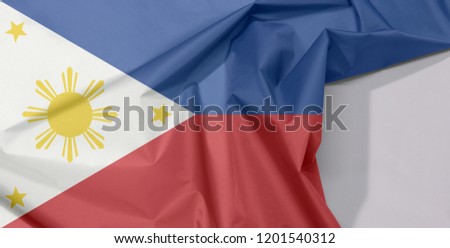 Philippines fabric flag crepe and crease with white space, a horizontal blue and red; white equilateral triangle based at the hoist, gold stars at its vertices, and gold sun at center.