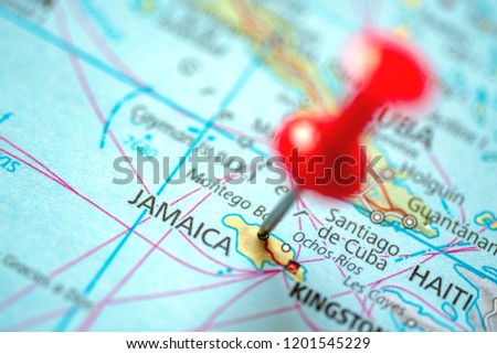 Push pin on the territory of Jamaica on the world map