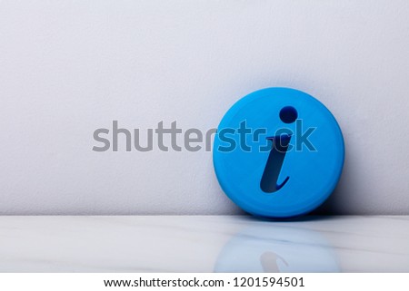 Photo Of Blue Information Icon Leaning On Wall
