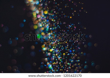 Abstract background with glittering defocused bokeh multicolor particles