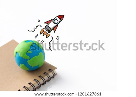 drawing of rocket above the earth , creativity  concept