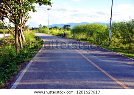 Road along the way with natural view on both side space of cloud at blue sky, view at the north of Thailand