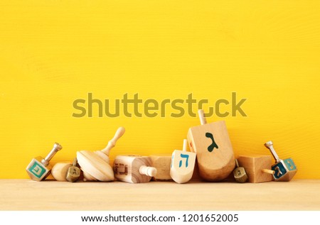 Image of jewish holiday Hanukkah with wooden dreidels (spinning top)