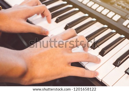 Boy's hand playing piano, Hands playing the synthesizer keyboard, Playing Piano, Hands of young woman playing piano.