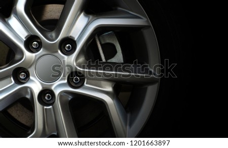 closeup alloy car wheels with soft-focus and over light in the background