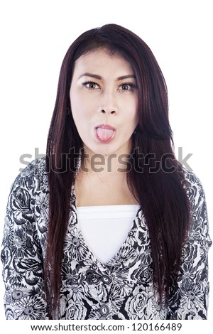 Portrait of a young woman with tounge stick out, isolated over white