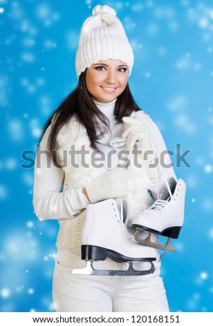 Beautiful woman in winter white clothes with skates.