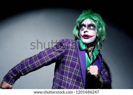 Halloween costume clown.Holiday photo of scary man. Thief in mask run from police. Halloween concept.