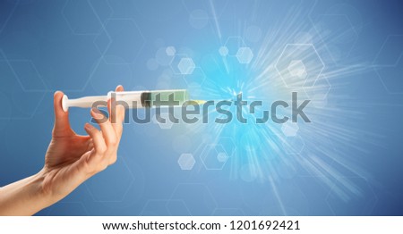 Female doctor hand holding syringe with shiny background