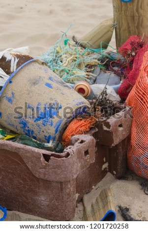 Plastic fishing containers nets and other rubbish washed up on a beach an example of the many pieces of plastic pollution in the sea around the world
