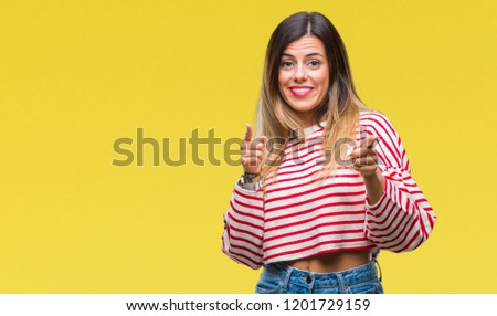 Young beautiful woman casual stripes winter sweater over isolated background pointing fingers to camera with happy and funny face. Good energy and vibes.