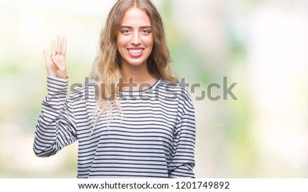 Beautiful young blonde woman wearing stripes sweater over isolated background showing and pointing up with fingers number four while smiling confident and happy.