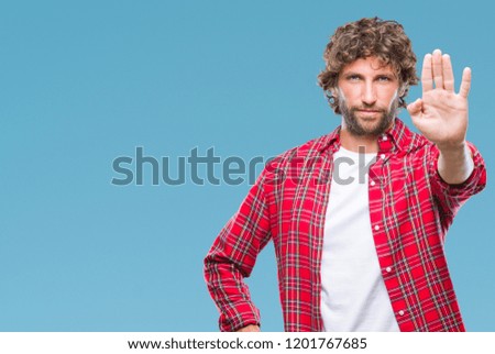 Handsome hispanic model man over isolated background doing stop sing with palm of the hand. Warning expression with negative and serious gesture on the face.