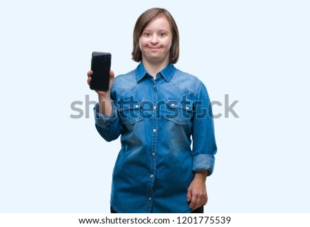 Young adult woman with down syndrome showing smartphone screen over isolated background with a happy face standing and smiling with a confident smile showing teeth