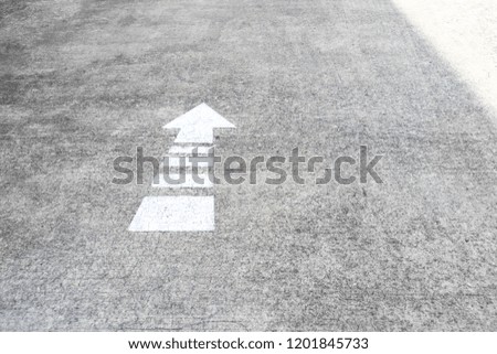 Arrow on the road and white color