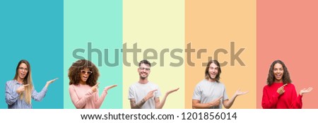 Collage of group of young people over colorful vintage isolated background amazed and smiling to the camera while presenting with hand and pointing with finger.