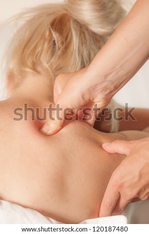 A physio gives myotherapy using trigger points on athlete woman Royalty-Free Stock Photo #120187480