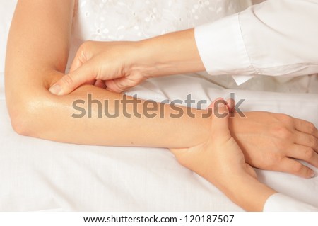 A physio gives myotherapy using trigger points on athlete woman Royalty-Free Stock Photo #120187507