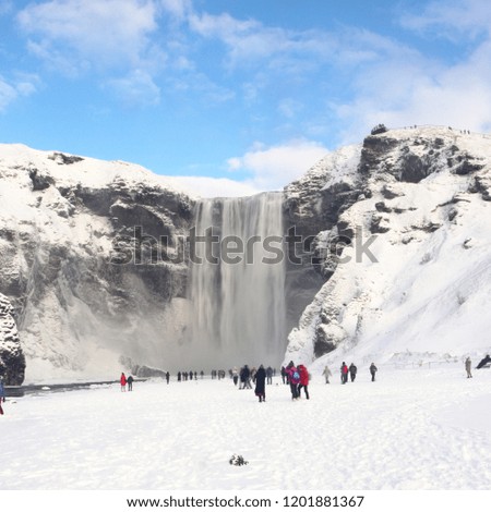 Skogafoss waterfall in Iceland with tourists