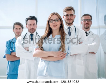 group of doctors and nurses standing in the hospital room