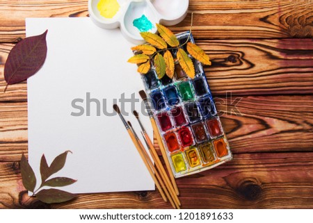 Set of artist accessories collection with autumn leaves. Canvas for painting, art brushes, palette. Top view