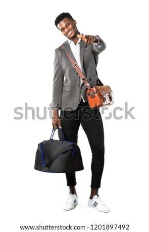 Full body of African american business man traveling with suitcases points finger at you with a confident expression on white background