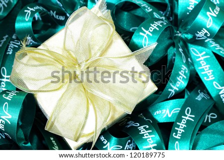 Golden gift box and green bow