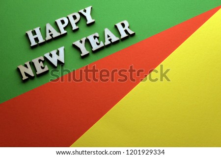 Green, red and yellow photo with wood letters new year.