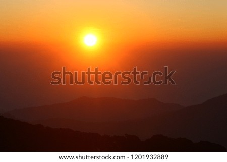 Sunrise over mountain Thailand Asia. Twilight sky background. Red Sun. Free space of text. Glow in the rays of sunlight.