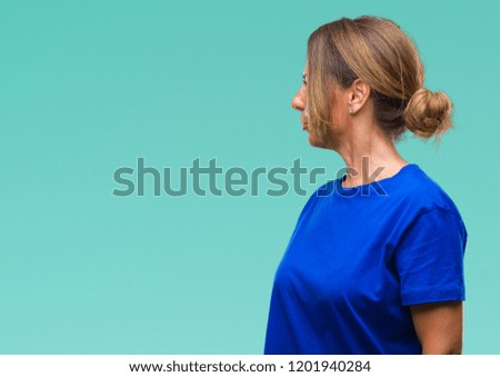 Middle age senior hispanic woman over isolated background looking to side, relax profile pose with natural face with confident smile.