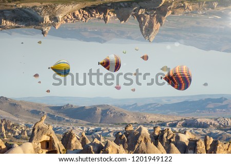 Unreal fantastic world, impossible surreal terrain, hot air balloons fly like fish in sky Royalty-Free Stock Photo #1201949122