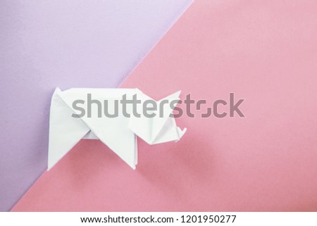 Chinese Zodiac Sign Year of Pig, White paper cut pig origami, Happy New Year 2019 year. Free space for text. Minimalism gradient background, xmas flatlay
