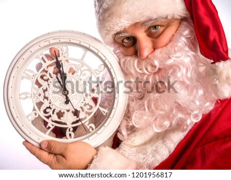 Joyful Santa holds the clock in his hands.