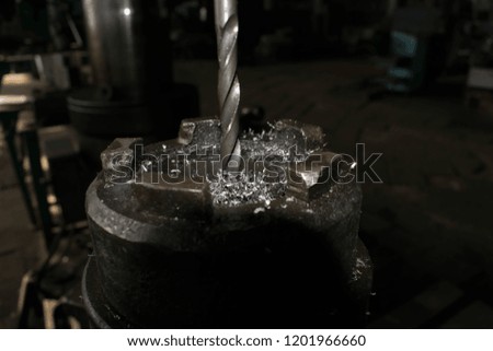 Drilling machine turning works metalworking production drill closeup for design background
