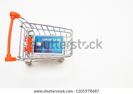 credit card in the shopping trolley on white background with copy space.