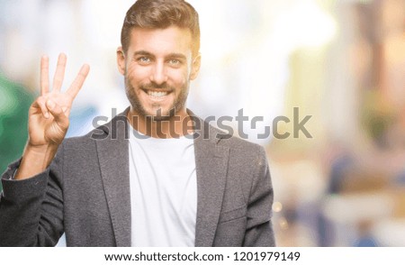 Young handsome business man over isolated background showing and pointing up with fingers number three while smiling confident and happy.