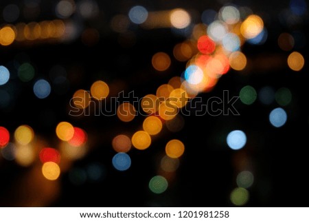 Bokeh of various colorful light within the black background of night sky conditions gives a peaceful feeling.