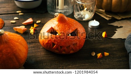 Preparing for the holiday Halloween, pumpkin, cut face, candles, wooden background