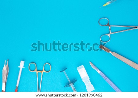 Flat lay of medical instruments on blue background. Mock up health care medical background.