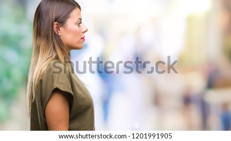 Young beautiful woman over isolated background looking to side, relax profile pose with natural face with confident smile.