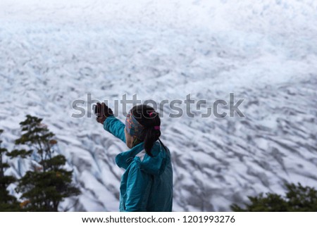 an unidentified woman taking picture of Grey glacier in Torres del Paine, Chile