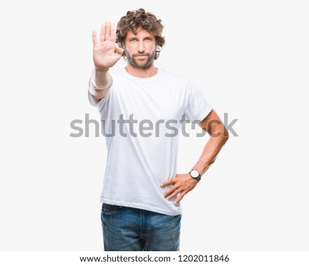 Handsome hispanic model man over isolated background doing stop sing with palm of the hand. Warning expression with negative and serious gesture on the face.