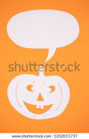 Paper halloween pumpkin on an orange background
