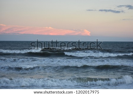 Waves and clouds at sunset