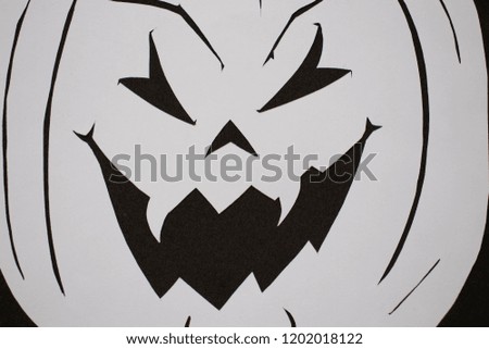 Paper halloween pumpkin on a black background