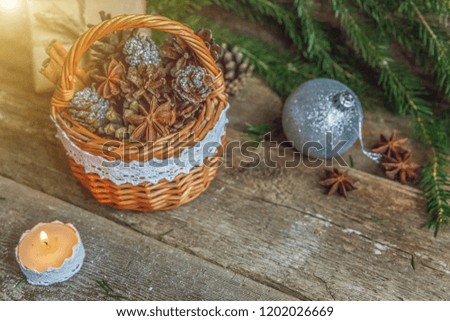 Christmas New Year composition with gift box fir branch basket pine cones candle on old shabby rustic wooden background. Xmas holiday december decoration to Russian tradition. Flat lay, copy space