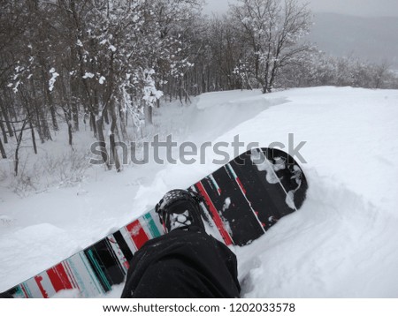 Man in the snow on a snowboard.